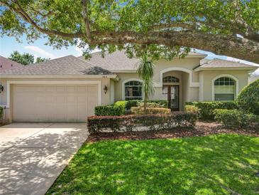 Charming single-story home with a well-manicured lawn and beautiful landscaping, showcasing its curb appeal at 903 Kersfield Cir, Lake Mary, FL 32746