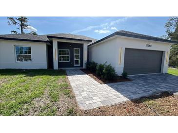 Charming single-story home boasts modern architecture, neat landscaping, and a welcoming entrance at 17380 Sw 36Th Ave Rd, Ocala, FL 34473