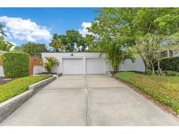 Detached two-car garage with a concrete driveway and beautifully landscaped yard at 1845 Delaney Ave, Orlando, FL 32806