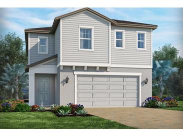 Charming two-story home with a two-car garage, beautiful landscaping, and a welcoming front entrance at 1888 Archer Dr, Minneola, FL 34715