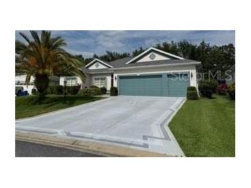 Charming single-story home with a well-manicured lawn and a two-car garage at 24125 Peekskill St, Leesburg, FL 34748