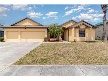 Charming one story home with a three car garage and well manicured lawn with beautiful landscaping at 2739 Village Pine Ter, Orlando, FL 32833