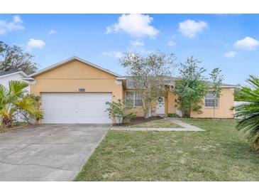 Charming single-story home featuring a well-maintained lawn and attached two-car garage at 4544 Point Look Out Rd, Orlando, FL 32808
