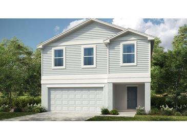 Charming two-story home featuring a modern exterior, garage, and professionally landscaped yard at 5657 Loggia Ln, Kissimmee, FL 34758