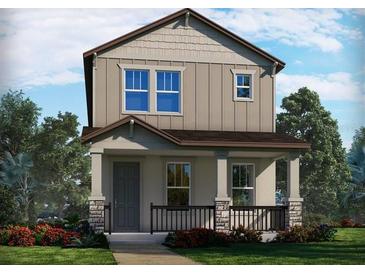 Charming two-story home featuring a welcoming front porch and beautifully landscaped front yard at 11941 Bracco St, Winter Garden, FL 34787