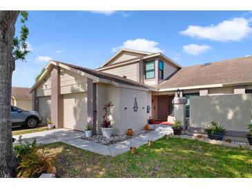 Inviting two-story home with a well-maintained lawn and a two car garage at 12133 Augusta Woods Cir, Orlando, FL 32824