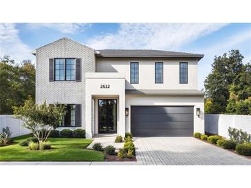 Beautiful two-story home featuring a modern design with brick and stucco accents at 2612 Musselwhite Ave, Orlando, FL 32804