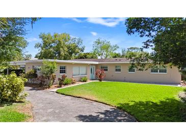Charming single-story home featuring a well-manicured lawn, mature landscaping, and a welcoming entrance at 101 E Lauren Ct, Fern Park, FL 32730