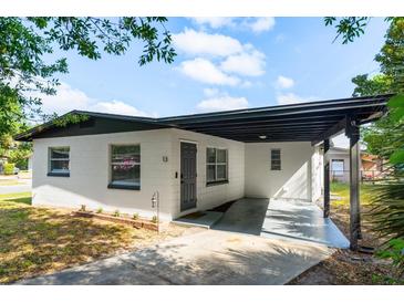 Charming single-story home with a covered front porch and well-maintained landscaping at 13 Fanfair Ave, Orlando, FL 32811