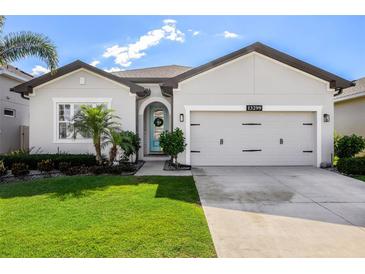 Charming single-story home with a well-manicured lawn and inviting curb appeal at 13299 Serene Valley Dr, Clermont, FL 34711