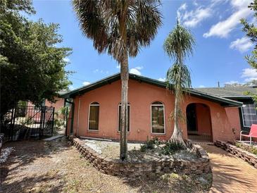 Charming home featuring a brick facade, arched windows, and mature palm trees in the front yard at 300 Broadview Ave, Altamonte Springs, FL 32701