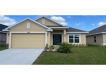 Charming single-story home featuring a manicured lawn and a two-car garage at 4224 Sagefield Dr, Harmony, FL 34773