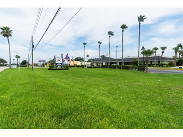 Lush lawn view features mature palms and landscaping, and nearby local attractions at 5245 W Irlo Bronson Memorial Hwy # 151, Kissimmee, FL 34746