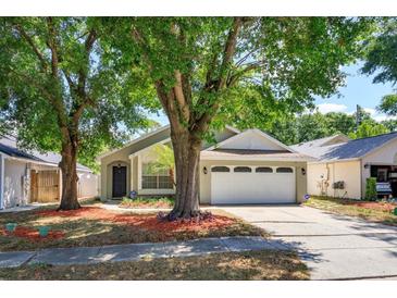 Charming single-story home with well-maintained lawn and mature trees providing ample shade at 1023 Royal Oaks Dr, Apopka, FL 32703