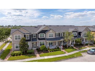 Beautiful multi-Gathering townhouse building with manicured landscaping and a well-maintained front yard at 11957 Vermillion Ave, Windermere, FL 34786