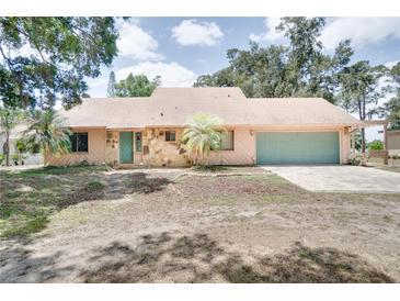 Charming single-story home with a two-car garage, stone accents, and well-manicured lawn at 12454 S Lake Mary Jane Rd, Orlando, FL 32832