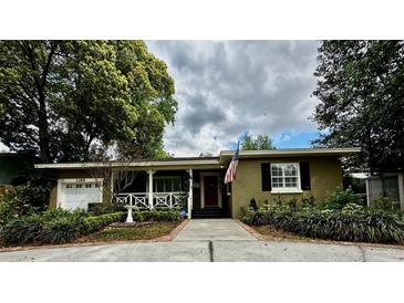 Charming single-story home with a brick walkway, covered porch, and well-maintained landscaping at 1399 Aloma Ave, Winter Park, FL 32789