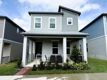 Charming two-story home with a covered porch and manicured landscaping at 4828 Abbeywood Aly, Winter Garden, FL 34787