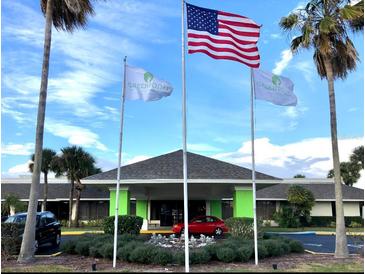 Attractive building with vibrant green trim, complemented by the American flag and mature landscaping at 5245 W Irlo Bronson Memorial Hwy # 170, Kissimmee, FL 34746