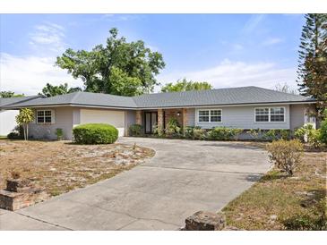 Charming single-story home with a well-maintained lawn and a large, inviting driveway at 2138 Whitehall Dr, Winter Park, FL 32792
