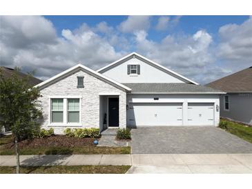 Charming single-Gathering home with a 3-car garage and beautifully paved driveway at 2926 Wordsmith Rd, Kissimmee, FL 34746