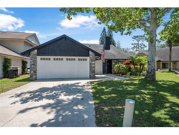 Charming single-Gathering home with a two-car garage, stone accents, and a well-maintained lawn at 3889 Biscayne Dr, Winter Springs, FL 32708