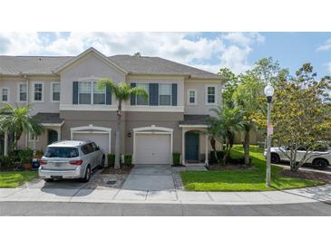 Charming townhouse showcasing a well-maintained lawn and neatly paved driveway, adding to its curb appeal at 561 Pinebranch Cir, Winter Springs, FL 32708