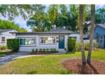 Charming single-story home featuring a landscaped front yard and welcoming blue front door at 1421 N Hampton Ave, Orlando, FL 32803