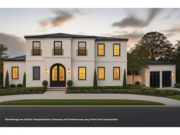 Stunning two-story home featuring a black tile roof, white stucco, arched front door, and manicured landscaping at 185 Sylvan Blvd, Winter Park, FL 32789