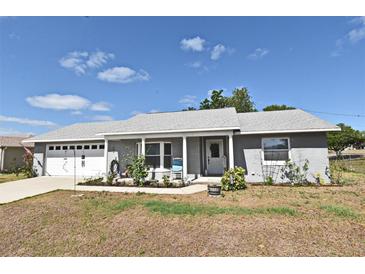 Charming single-story home with a well-manicured lawn and lovely landscaping, perfect curb appeal at 2102 Urbana Ave, Deltona, FL 32725