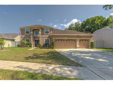 Charming two-story home with a manicured front lawn and a spacious three-car garage at 269 Englenook Dr, Debary, FL 32713