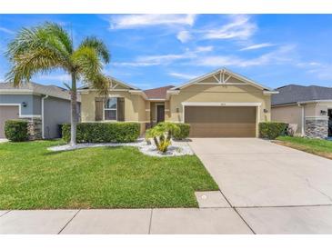 Charming single-Gathering home with a well-manicured lawn, lush landscaping, and a two-car garage at 2815 Shelburne Way, St Cloud, FL 34772
