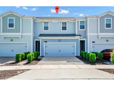 Charming two-story townhome featuring an attached garage, well-maintained landscaping, and inviting curb appeal at 2919 Verse St, Kissimmee, FL 34746