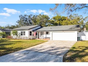 Charming one-story home with a manicured front lawn and a two-car garage, offering classic curb appeal at 1231 Glastonberry Rd, Maitland, FL 32751