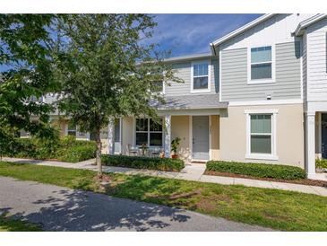 Charming townhouse with a quaint front patio, perfect for enjoying the outdoors at 2203 Gopher Tortoise Ter, Oakland, FL 34787