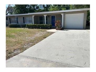 Charming single-story home featuring a well-maintained lawn, covered porch and a convenient attached garage at 2886 Carew Ave, Winter Park, FL 32789