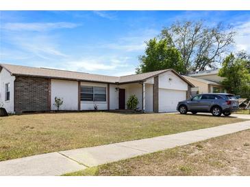 Charming single-story home featuring a well-maintained lawn and an attached garage at 3041 Dikewood Ct, Winter Park, FL 32792