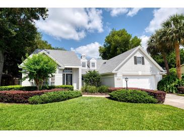 Beautifully landscaped, two-story home with a well-manicured lawn and lovely curb appeal at 308 Pine Shadow Ln, Lake Mary, FL 32746