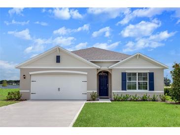 Charming single-Gathering home featuring a two-car garage, manicured lawn, and traditional architectural details at 5133 Masser Rd, St Cloud, FL 34772