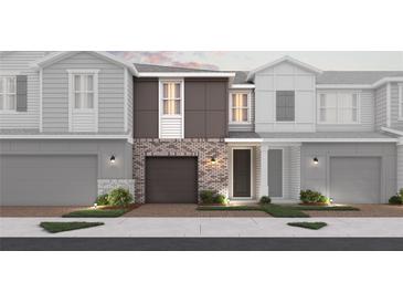 Charming townhome showcases modern brick accents, a private garage, and inviting curb appeal at 540 Southern Edge Way, Sanford, FL 32771