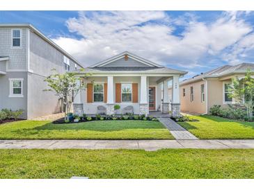 Charming single-story home with a manicured lawn, covered porch, and stone accents, creating inviting curb appeal at 744 Yukon Ln, Debary, FL 32713