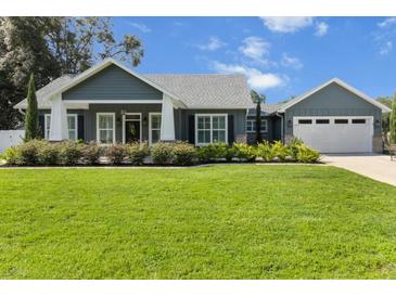 Charming home boasts lush landscaping, well-manicured lawn, and inviting curb appeal at 8717 Se 156Th St, Summerfield, FL 34491