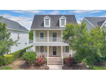Charming two-story home with a welcoming front porch and second story balcony at 1131 Indigo Dr, Kissimmee, FL 34747