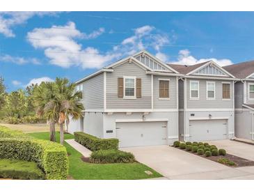 Charming two-story townhome with well-maintained landscaping and attached one car garage at 12307 Turtle Grass Dr, Orlando, FL 32824