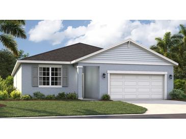 Charming one-story home with a two car garage, well-maintained lawn, and beautiful landscaping at 1247 Blue Daze Ln, Eustis, FL 32726