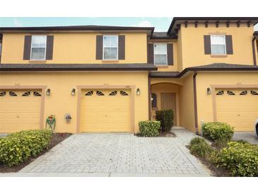 Inviting two-story townhouse with a two-car garage and well-maintained landscaping at 1441 Twin Trees Ln, Sanford, FL 32771