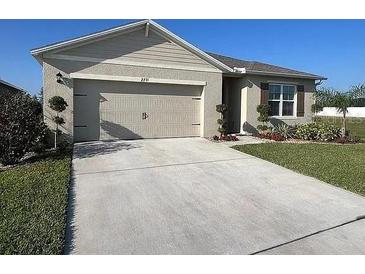 Charming single-Gathering home with a two-car garage, manicured lawn, and a welcoming facade at 2711 Neverland Dr, New Smyrna Beach, FL 32168
