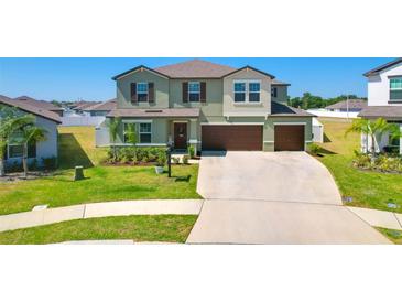 Beautiful two-story home featuring a well-manicured lawn and a two-car garage at 2995 Flying Blackbird Rd, Bartow, FL 33830