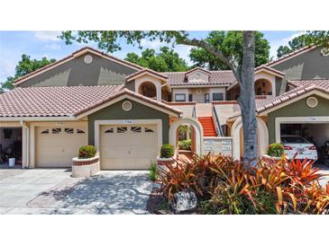 Inviting home exterior featuring a neutral color palette, tile roof, and attached garage at 7768 Sugar Bend Dr # 7768, Orlando, FL 32819