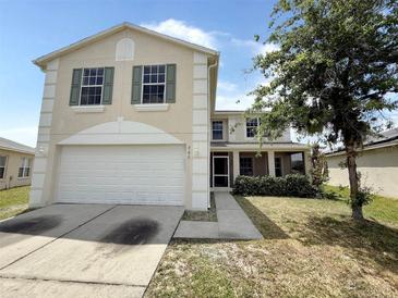 Two-story home featuring a two-car garage, lawn, and neutral paint at 786 Crystal Bay Ln, Orlando, FL 32828